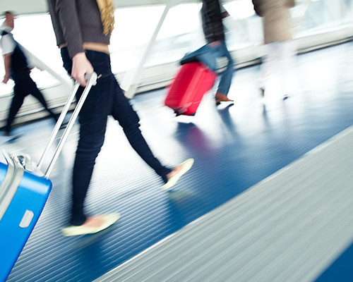 People Walking Through Airport